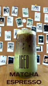 Iced Matcha Espresso in front of our Wall of Fame